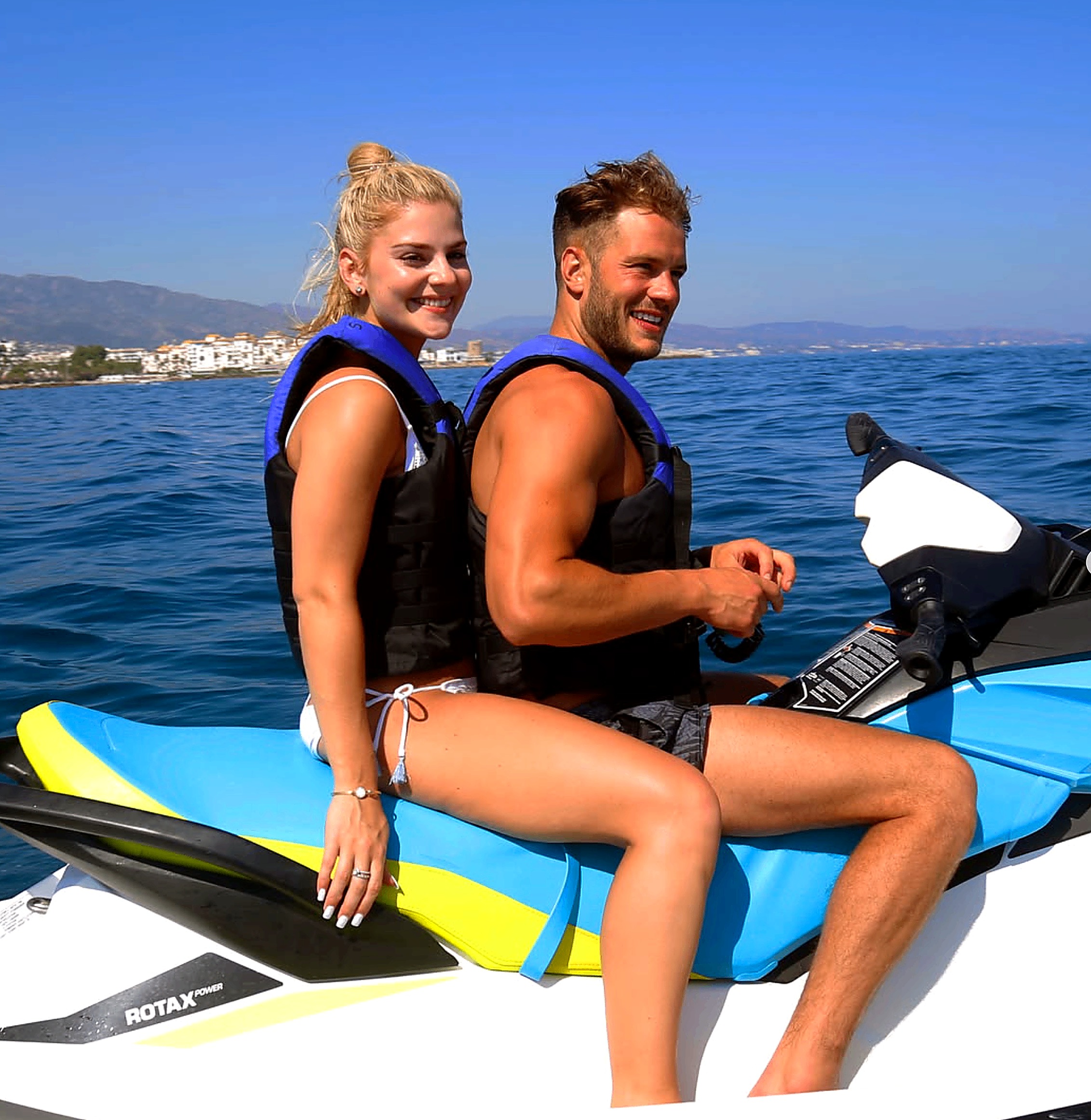 Couple smiling on a blue Sea-Doo jet ski during a Marbella excursion