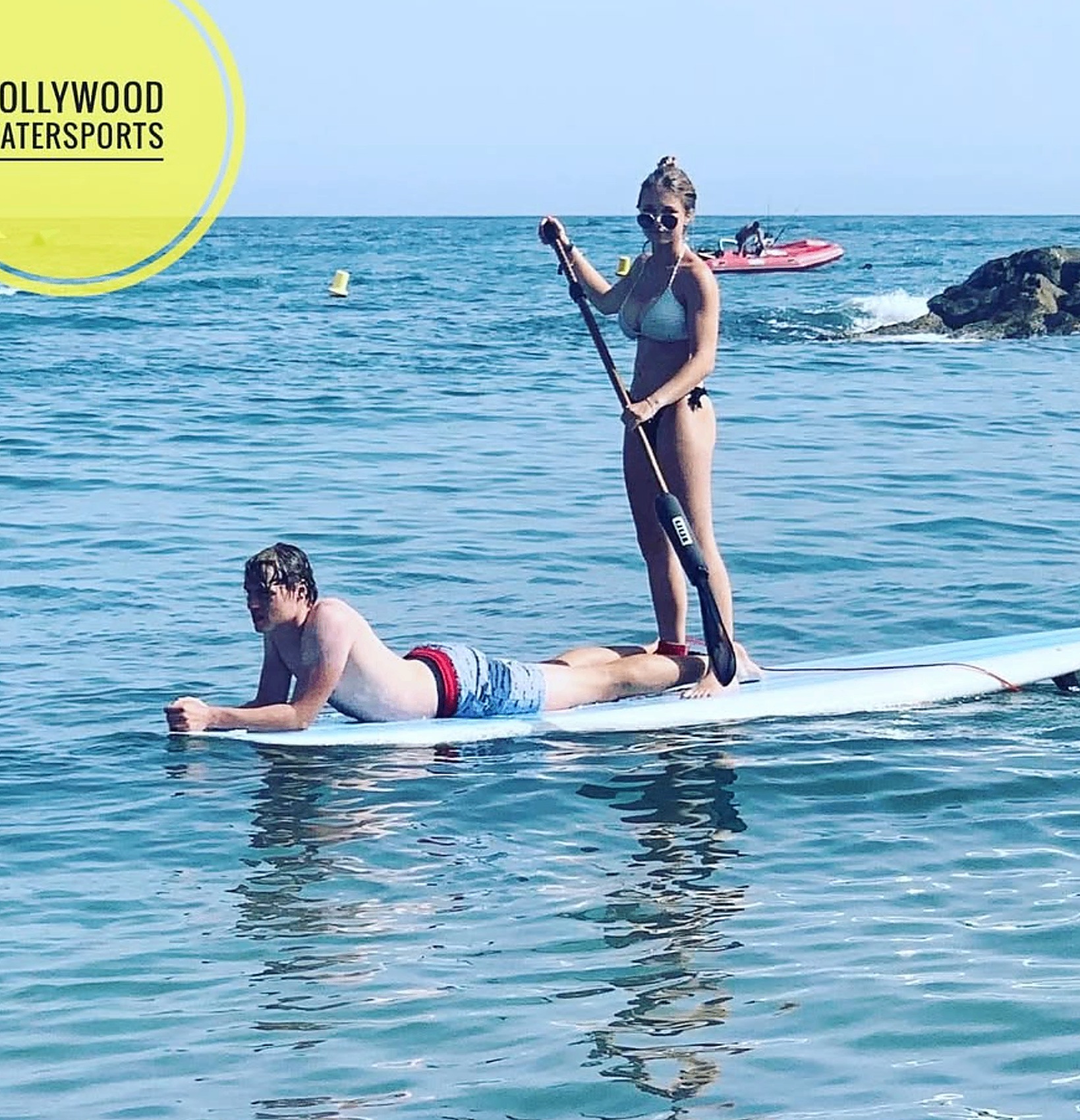 Couple enjoying stand-up paddleboarding together off Puerto Banús