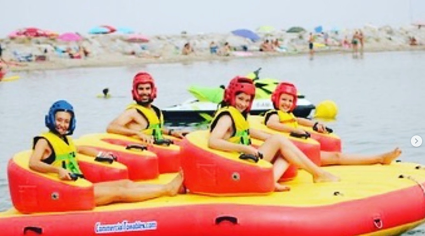 Sofa inflatable lined up with helmets on the beach
