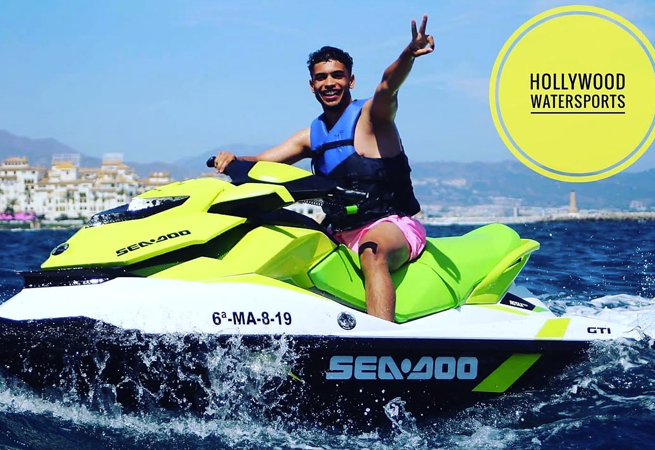 Rider throwing a peace sign on a Sea-Doo GTI jet ski off the Marbella coast