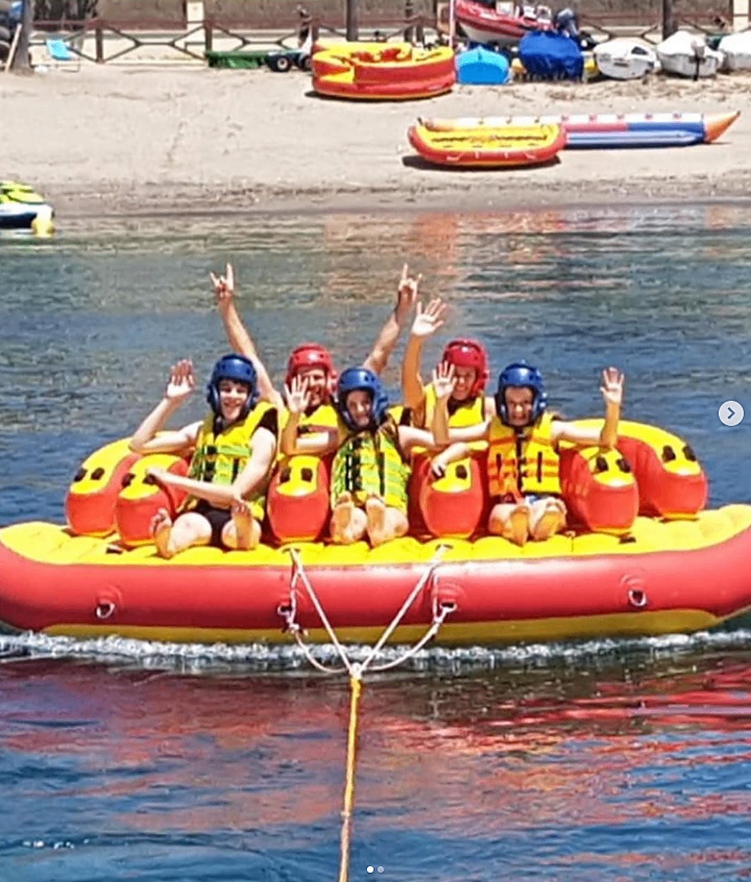 Group of riders cheering on the sofa inflatable at Puerto Banús